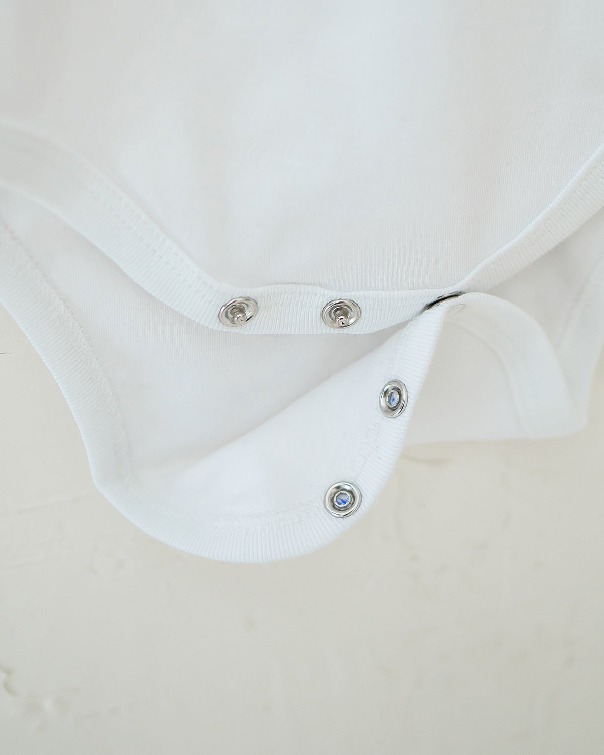 NM X LEBEAR BINKY BEAR ONESIE IN WHITE