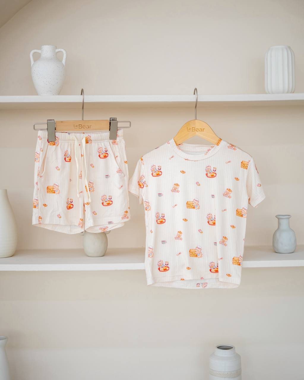 LeBear Kaya Butter Toast Kids TENCEL™ Lounge Set displayed on hanger featuring matching short sleeve top and shorts with breakfast print.