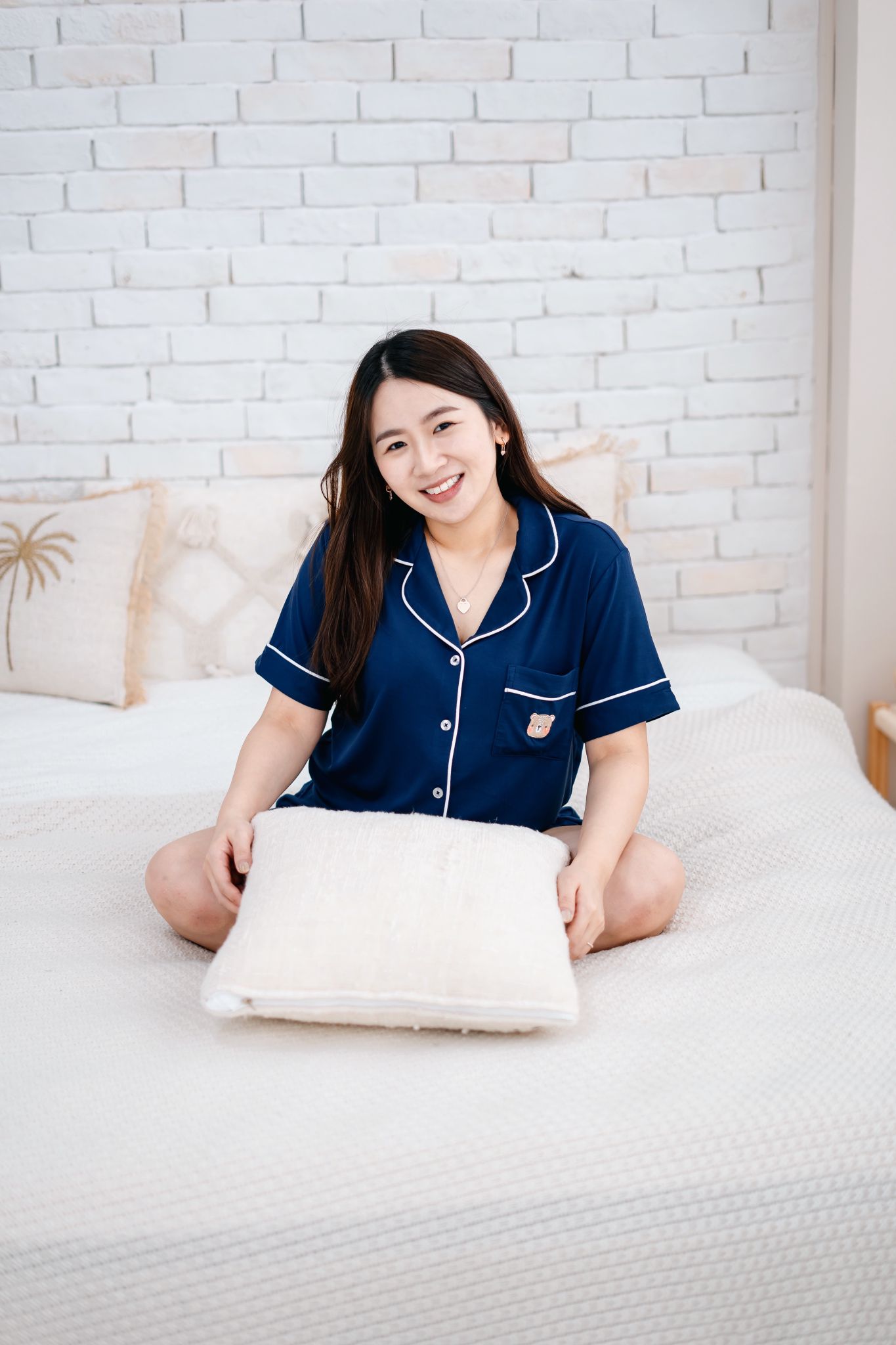 Woman in navy short-sleeve pyjamas made from OEKO-TEX® certified bamboo fabric, silky soft and eco-friendly sleepwear
