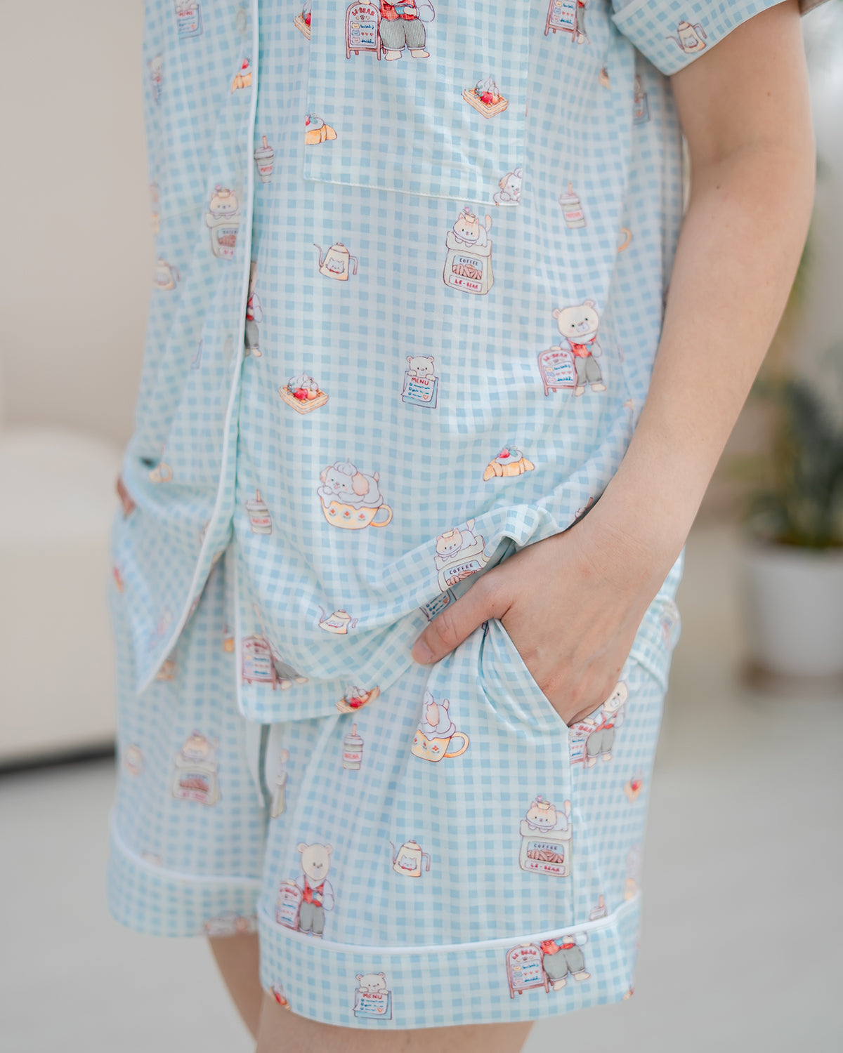 Close-up of LeBear Bearista Bluebell adult bamboo pyjamas showcasing the exclusive café-inspired teddy bear print on blue gingham bamboo fabric.