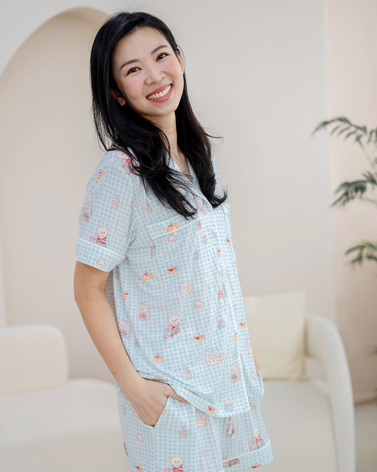Front three-quarter view of LeBear Bearista Bluebell adult bamboo pyjamas featuring a blue gingham design and café-inspired teddy bear print.