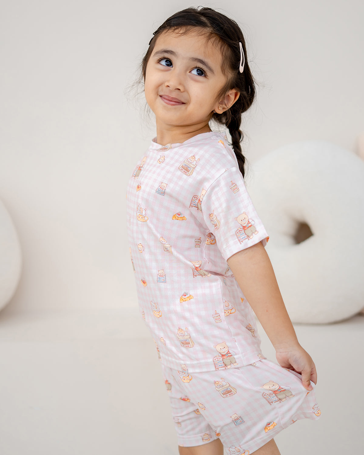Side view of a girl wearing LeBear Bearista Blush Gingham bamboo lounge set for kids, designed for all-day comfort and play.