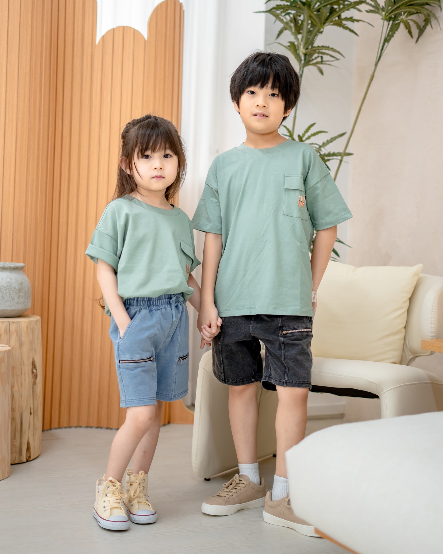 Kids wearing LeBear light wash denim shorts with zipper pockets, styled with green oversized tees for a casual sibling outfit