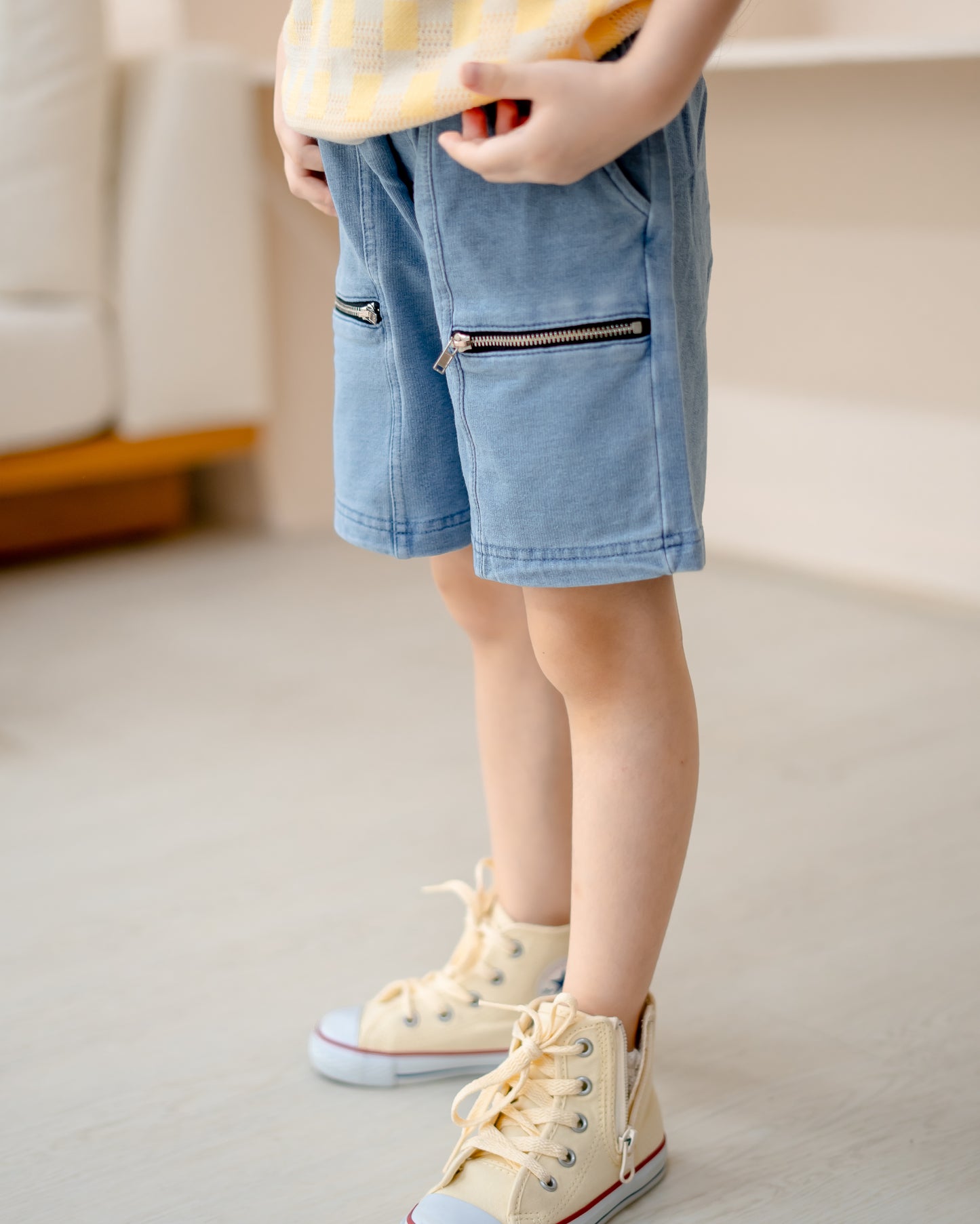 Close-up of LeBear kids light wash denim shorts with stylish double zipper pockets and soft denim fabric