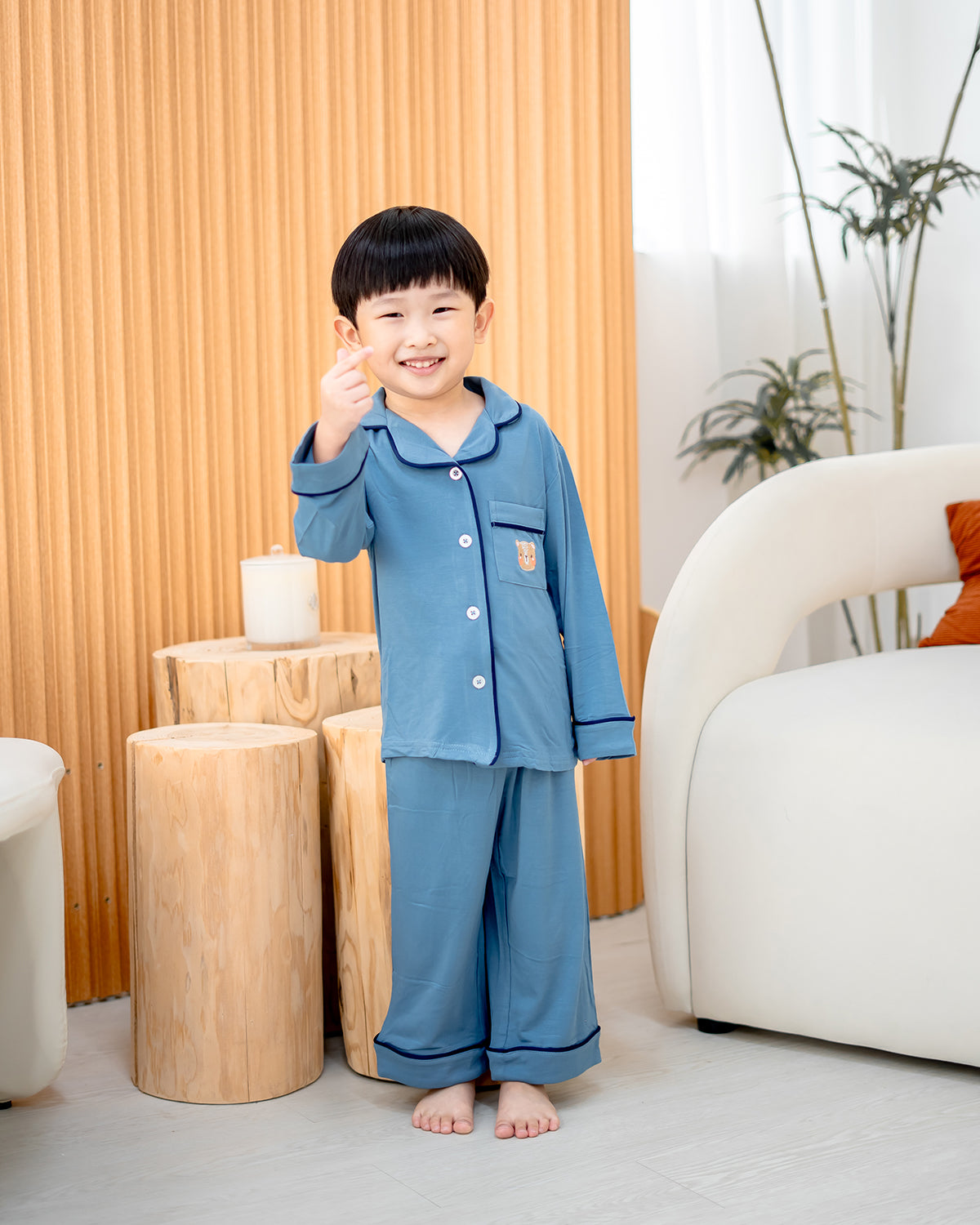Child smiling in LeBear bamboo pyjamas Dusk Blue, soft and breathable kids sleepwear set
