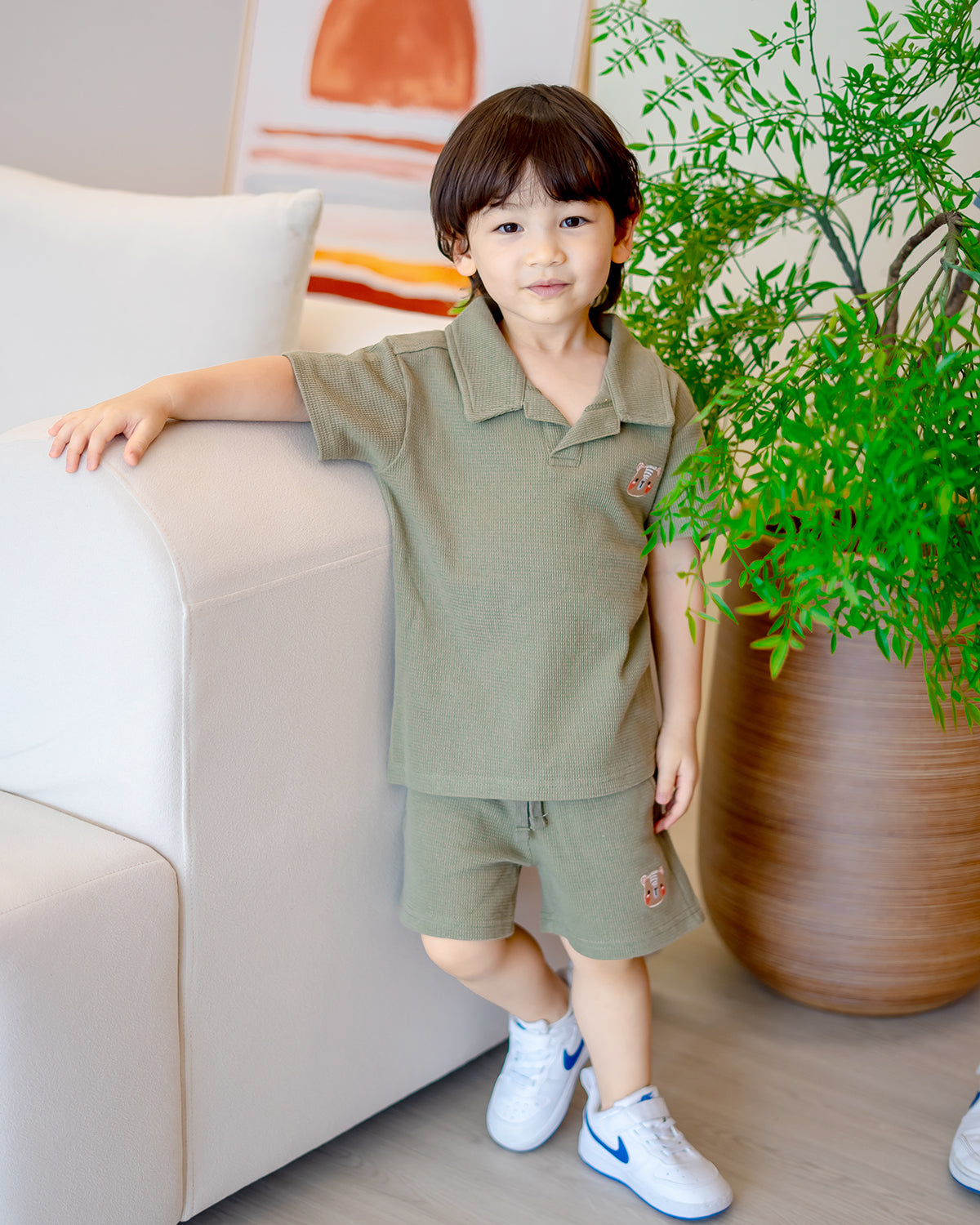 Boy wearing LeBear Waffle Collar Set in green, made from 100% premium cotton with fluffy bear embroidery