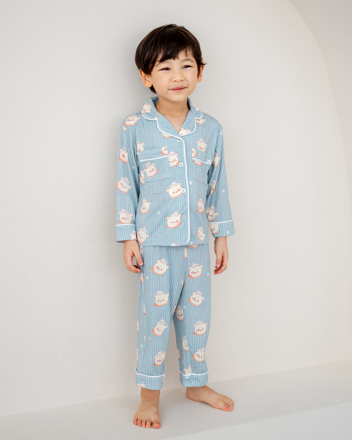 Child wearing Little Dreamer kids bamboo pyjamas pants set in aqua blue