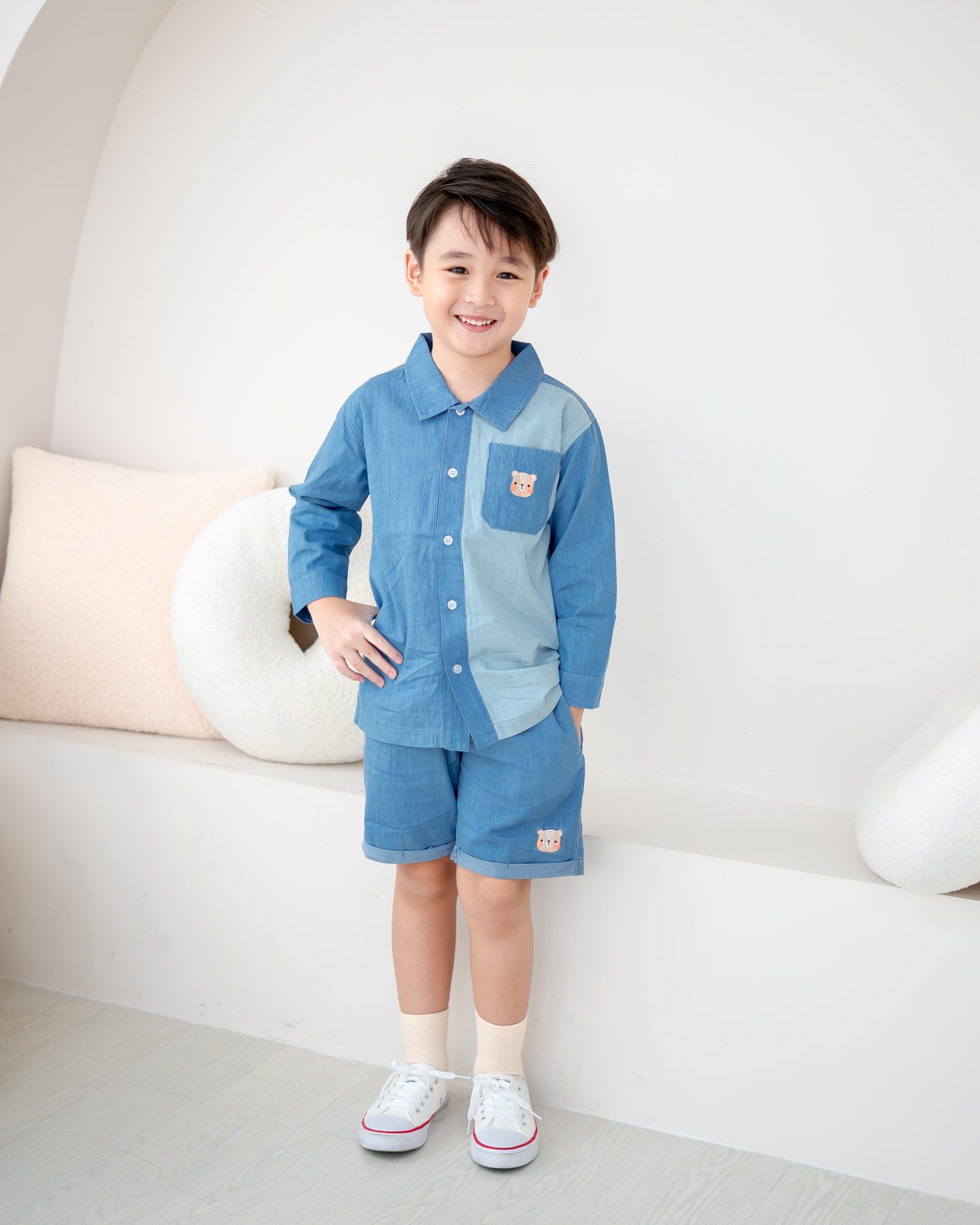 Boy wearing LeBear two-tone denim shirt featuring signature bear embroidery