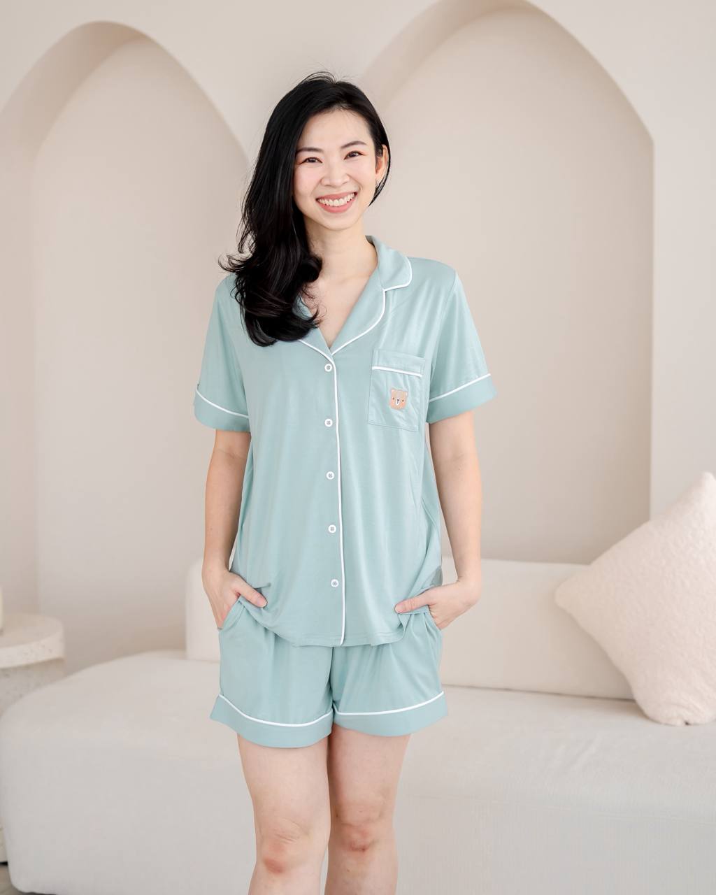 Woman wearing bamboo pyjamas in Tiffany Green by LeBear