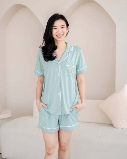 Woman wearing bamboo pyjamas in Tiffany Green by LeBear
