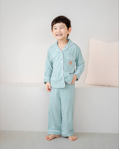 Child wearing bamboo pyjamas in Tiffany Green by LeBear
