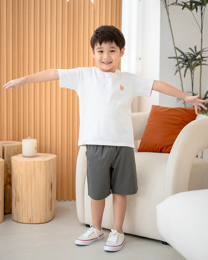 Boy wearing white tee and Everyday Essential Shorts in Charcoal – easy everyday outfit