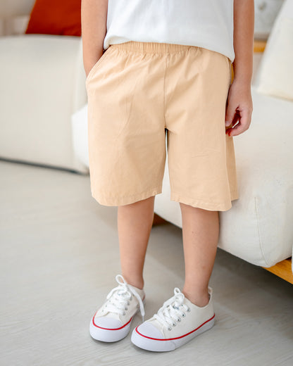 Child wearing Everyday Essential Shorts in Sand Dunes – elastic waist and side pockets