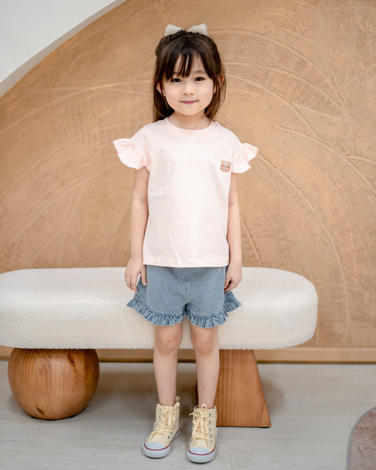 Girl’s blush pink Odell cotton top styled with denim ruffle shorts, comfortable and soft breathable kids fashion