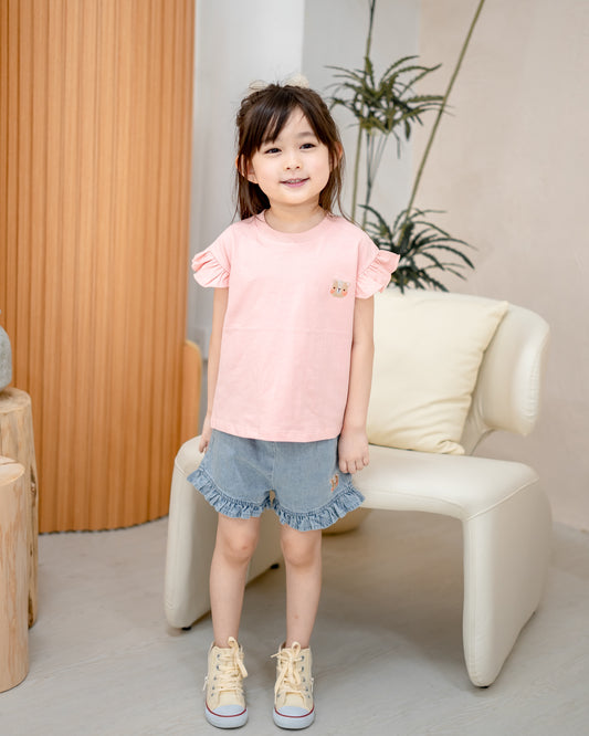 Girl’s outfit with Odell cotton pink shirt and denim ruffle shorts, soft breathable kids fashion for daily wear