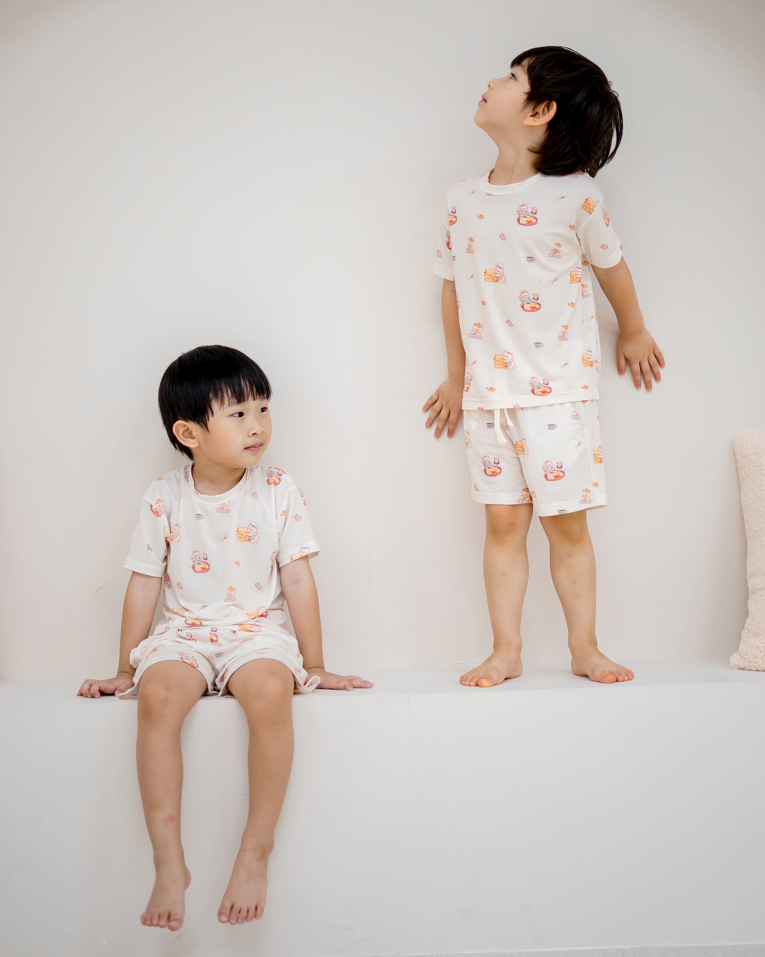 Two boys wearing LeBear Kaya Butter Toast Kids TENCEL™ Lounge Set in relaxed home lifestyle setting.