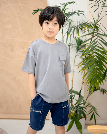 Boy wearing dark wash denim shorts with soft and slightly stretchable fabric, stylish kidswear for daily comfort