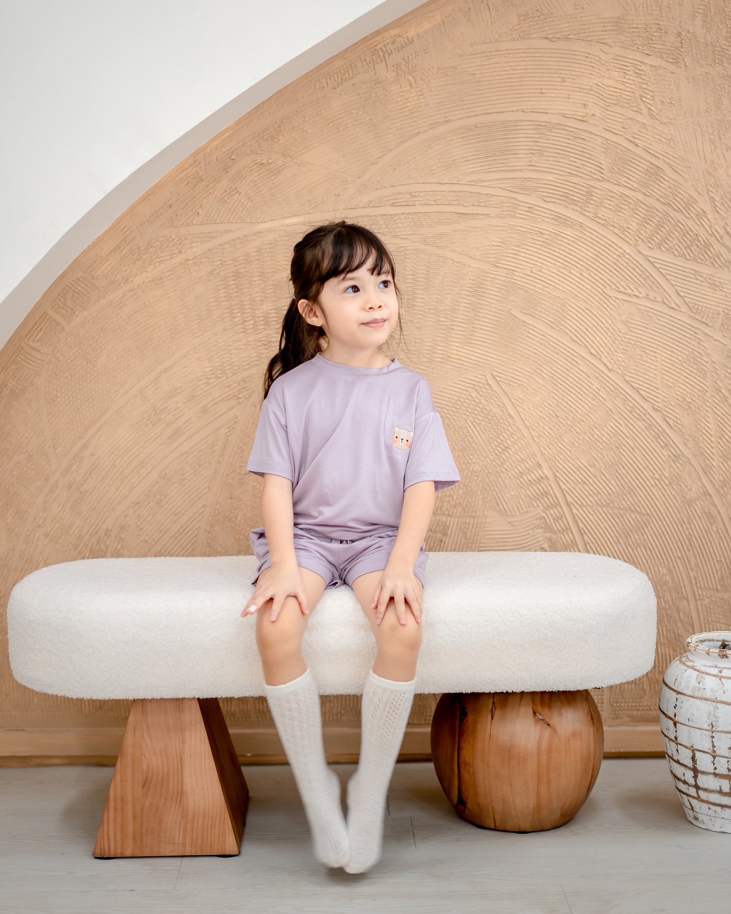 Front view of girl in lilac kids loungewear crafted from sustainable OEKO-TEX® certified TENCEL™ Lyocell fabric