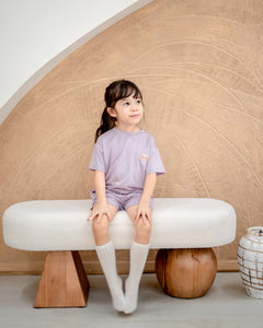 Front view of girl in lilac kids loungewear crafted from sustainable OEKO-TEX® certified TENCEL™ Lyocell fabric
