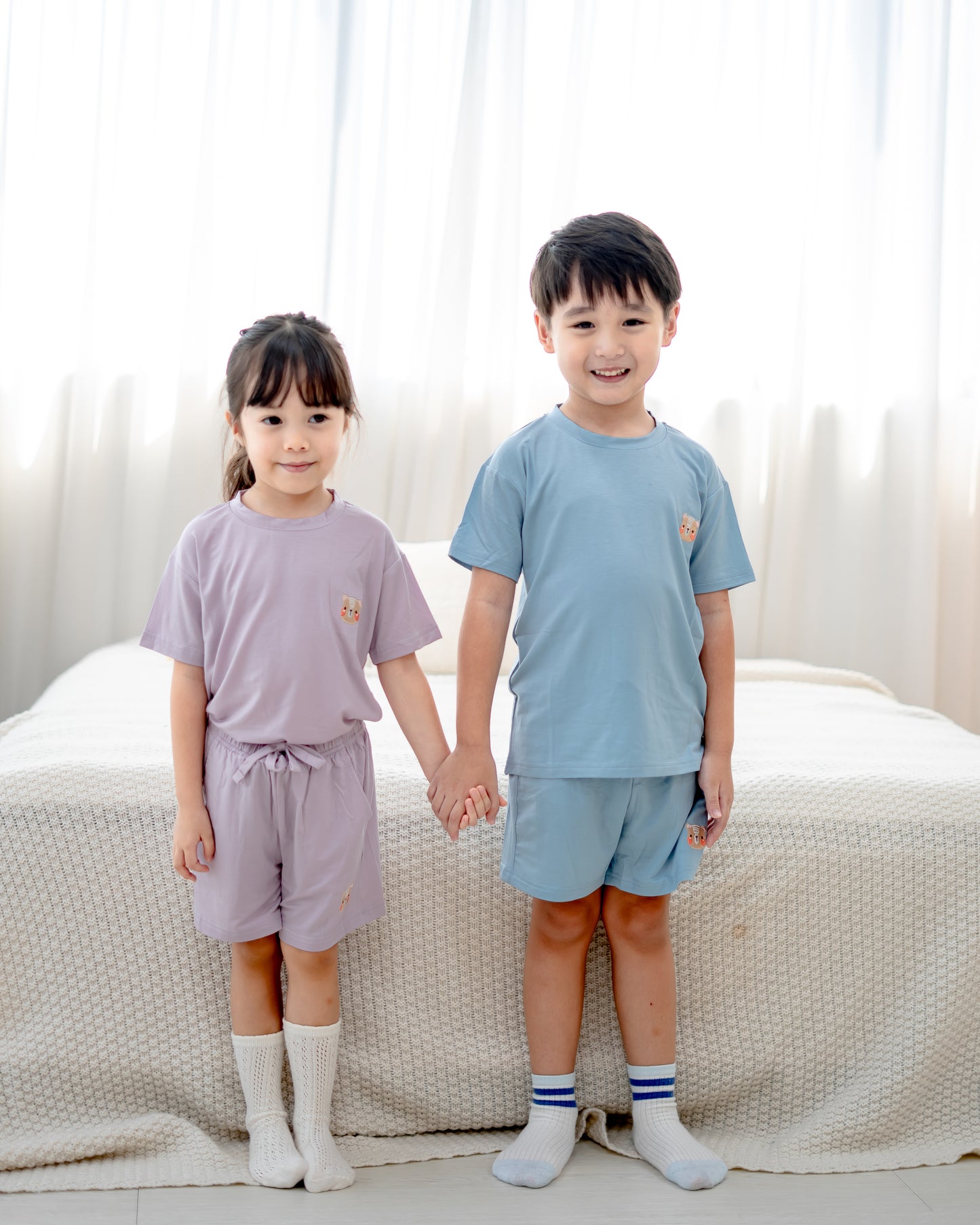 Kids in lilac and skyblue loungewear made from OEKO-TEX® certified TENCEL™ Lyocell, soft and sustainable fabric