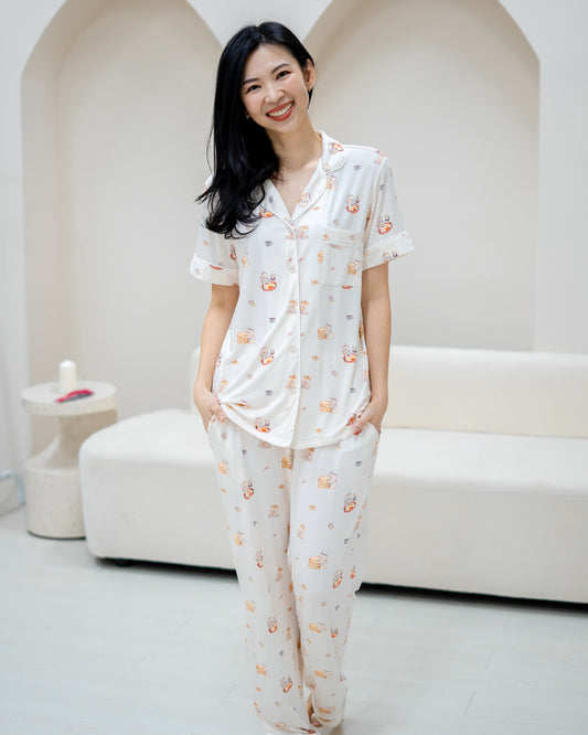 Woman smiling in LeBear Adult Kaya Butter Toast Bamboo Pyjamas Pants Set made with cooling bamboo fabric for sleepwear comfort.