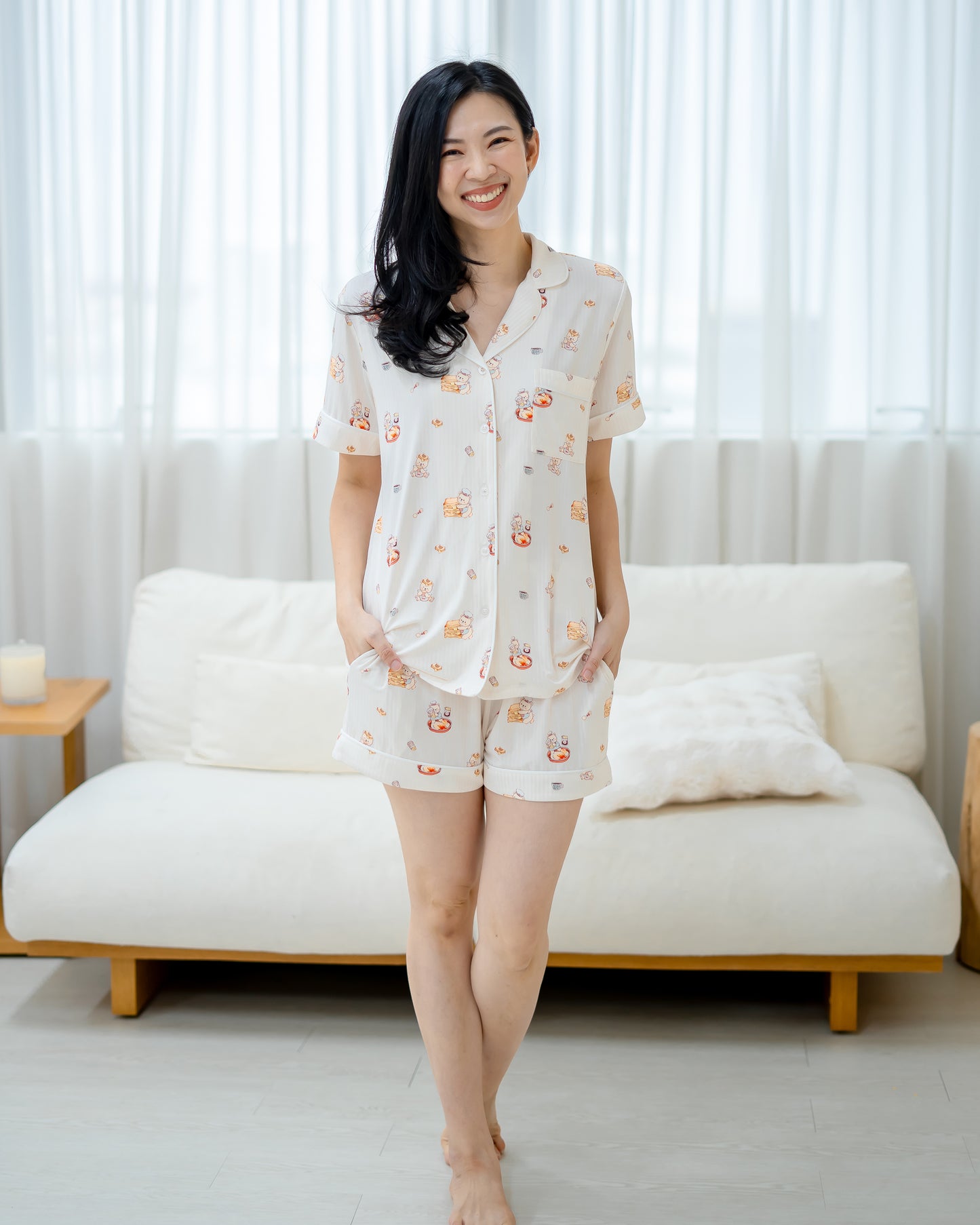 Front view of woman wearing LeBear Adult Kaya Butter Toast Bamboo Pyjamas Shorts Set with button shirt and matching shorts.