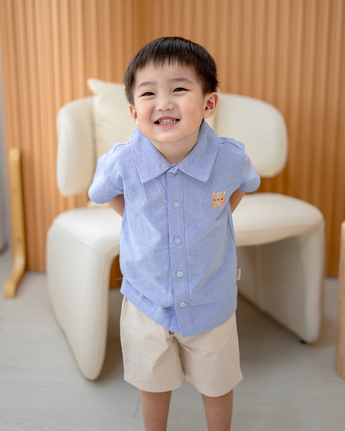 Young boy wearing LeBear Atelier Button Down Shirt Blue in lifestyle setting