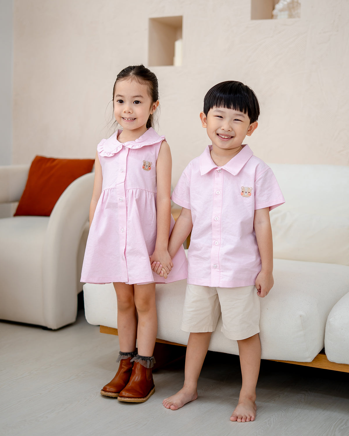 “LeBear Pink Atelier Ruffle Dress and boys Pink Atelier Shirt – matching siblings outfit standing”