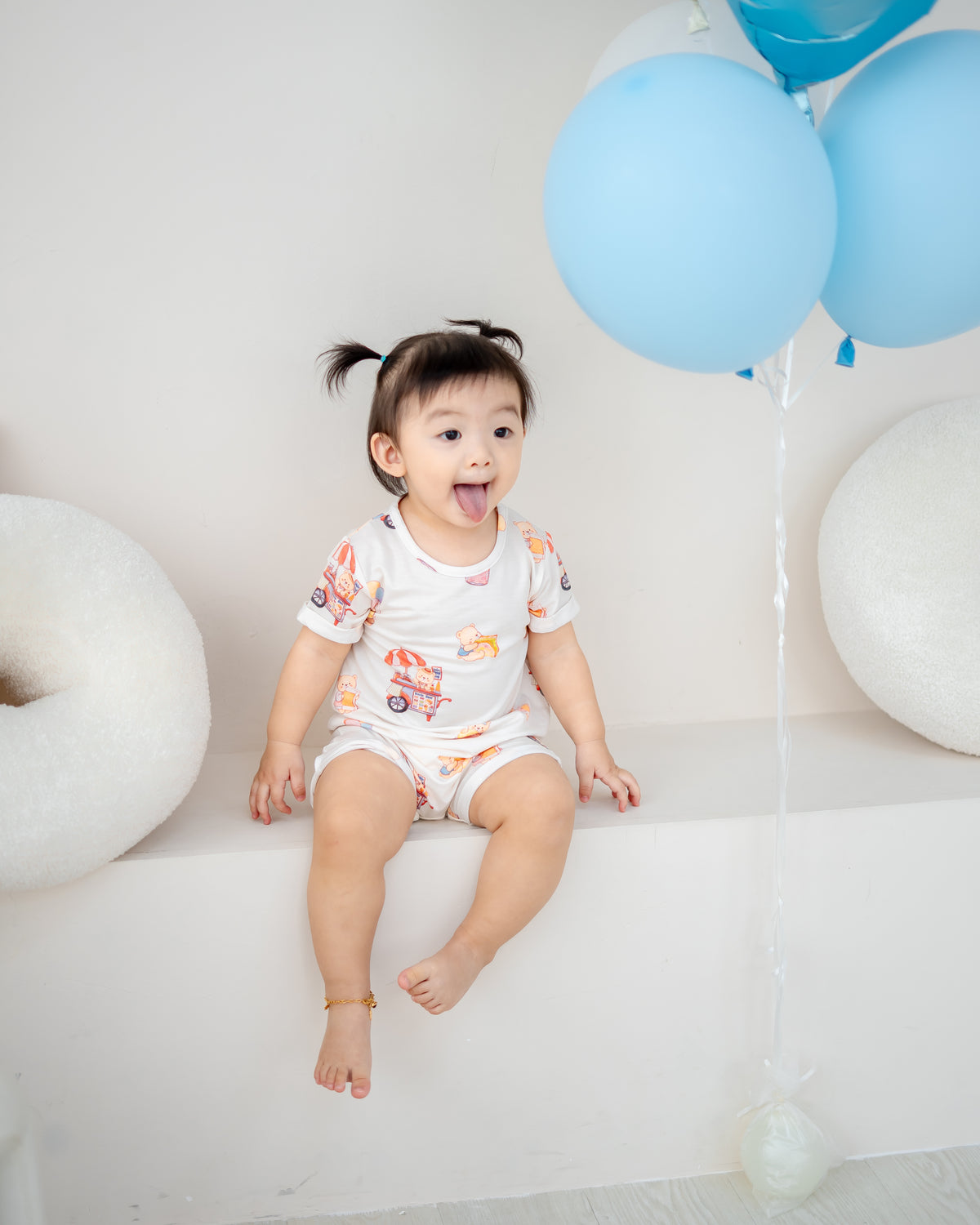 Baby in Uncle Bear Ice Cream Truck TENCEL™ onesie with playful bear print