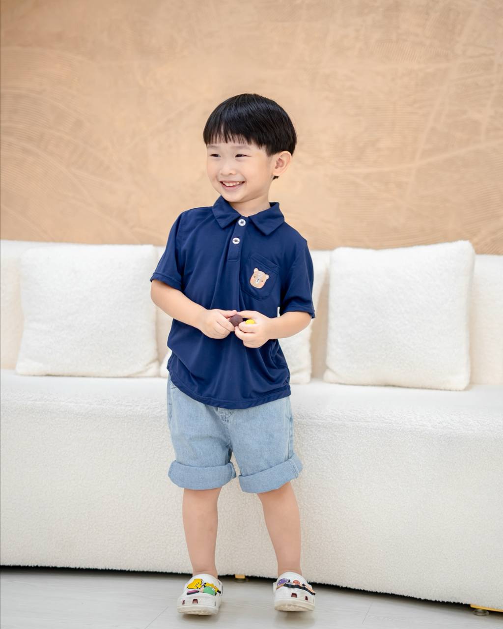 "Lebear bamboo polo tee in navy – front view on child model"
