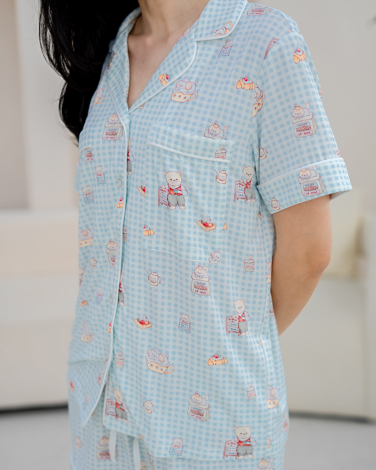 Upper body view of LeBear Bearista Bluebell bamboo pyjama set with relaxed fit, white piping and signature café-themed print.