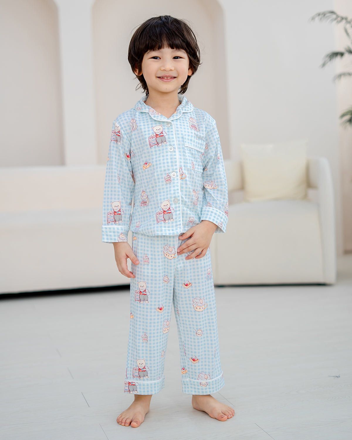 Front view of LeBear Bearista Bluebell Gingham kids bamboo pyjamas featuring a relaxed fit and adorable café-inspired print.