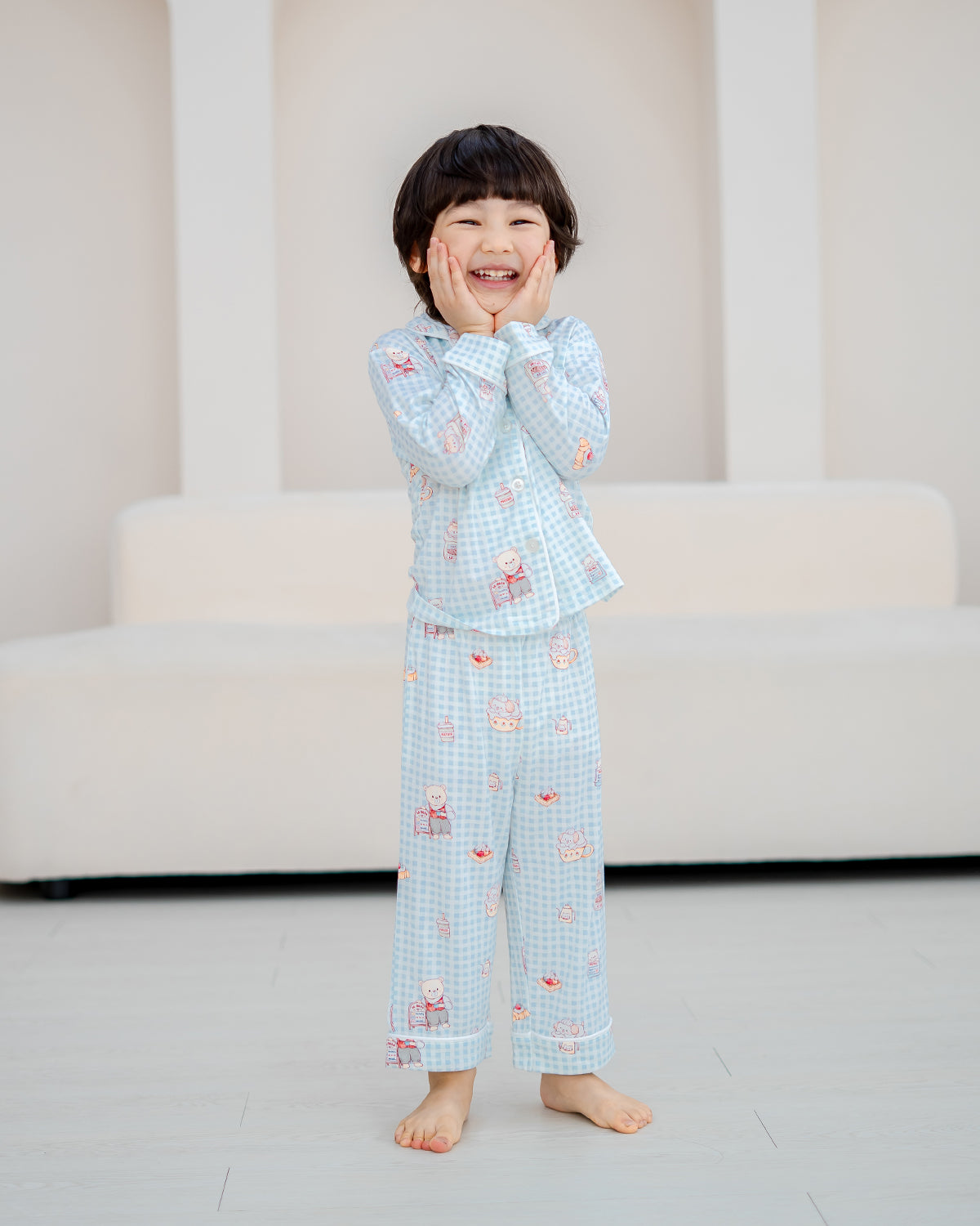 Smiling child in LeBear Bearista Bluebell Gingham bamboo pyjamas made from buttery-soft bamboo fabric for sensitive skin.