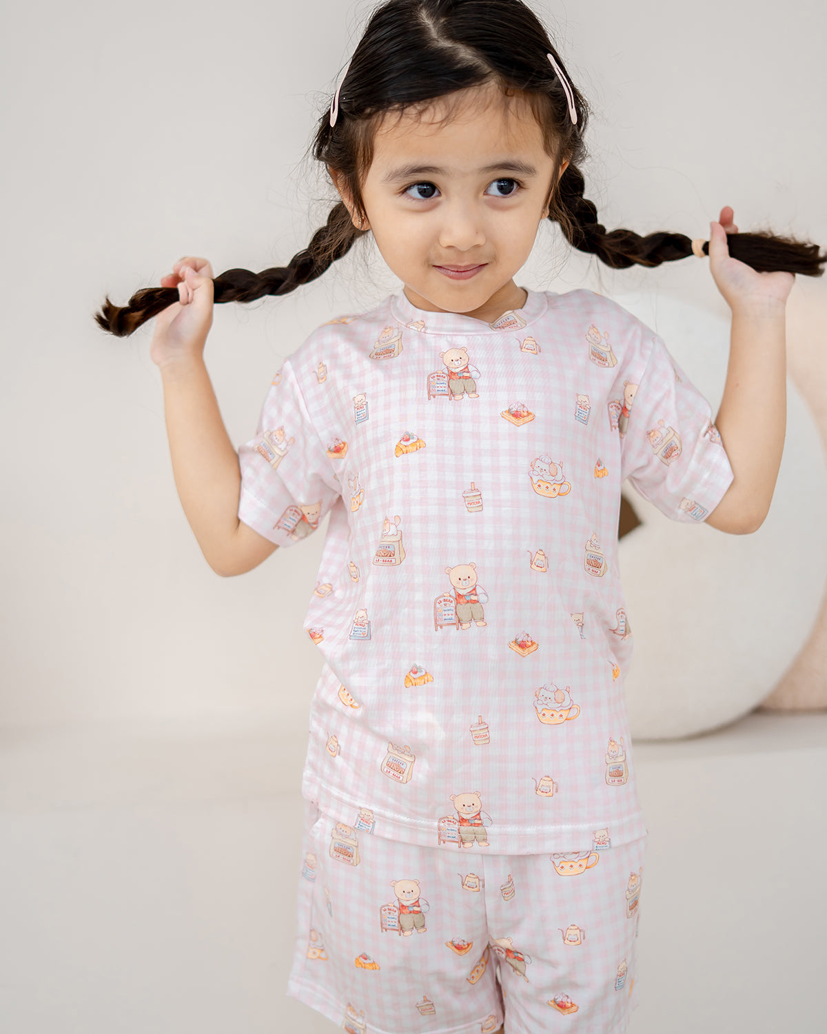 Girl wearing LeBear Bearista Blush Gingham kids bamboo lounge set featuring a café-inspired bear print and soft breathable bamboo fabric.