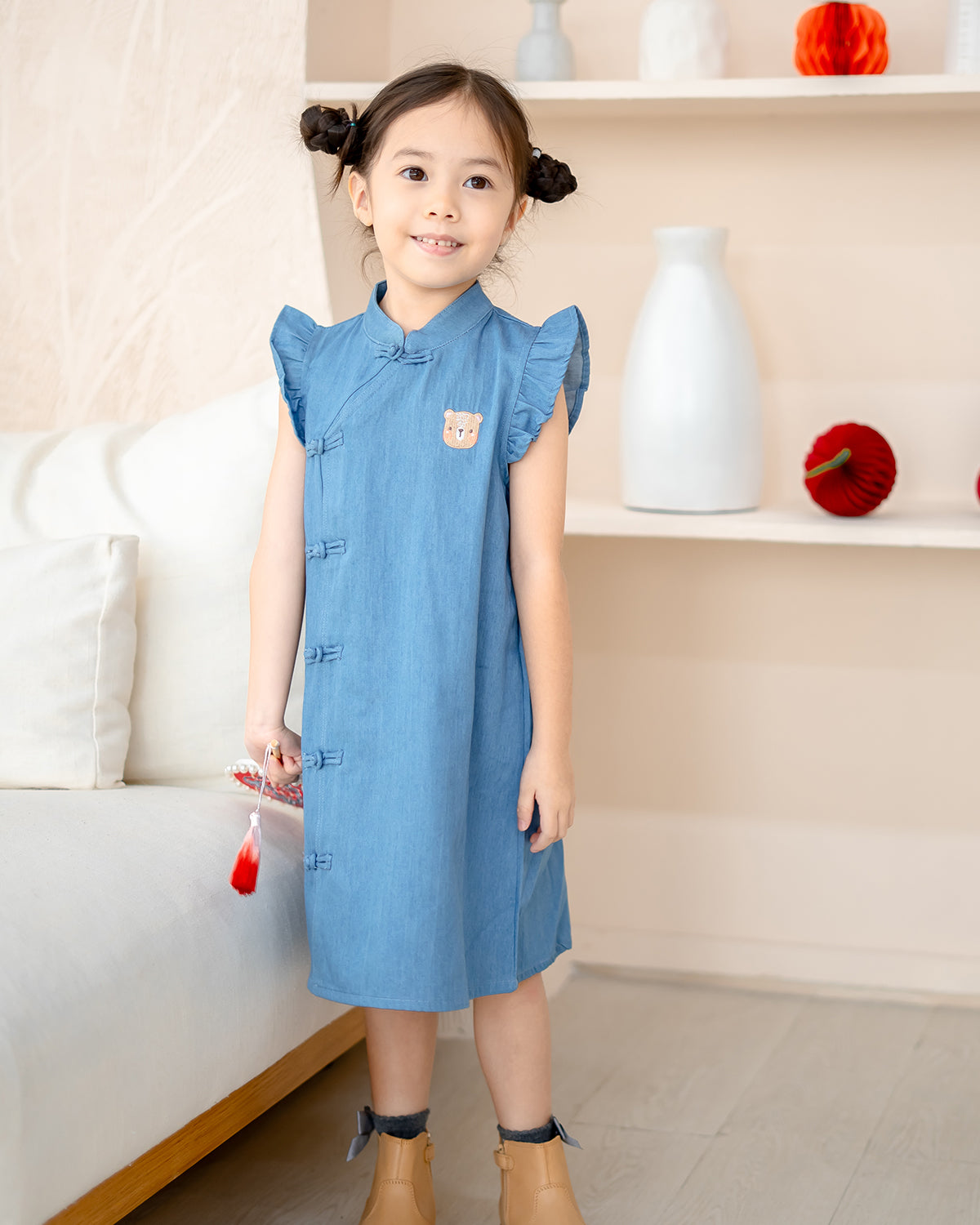 Girl wearing LeBear Denim Serenity Cheongsam with flutter sleeves