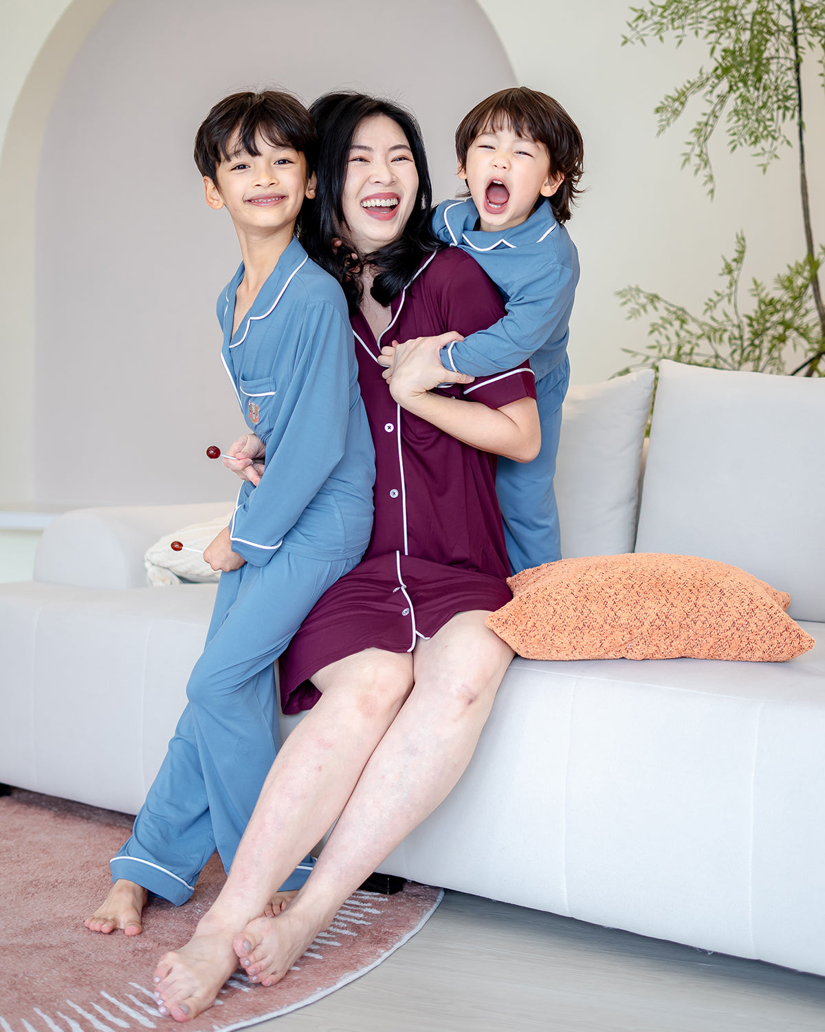 Mother in LeBear Wine Bamboo Pyjamas Dress hugging kids in Dusk Blue Bamboo Pyjamas for family matching look