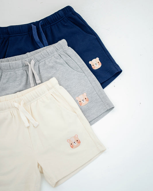 LeBear Kids bear embroidered shorts in beige, grey, and navy flat lay for color comparison.