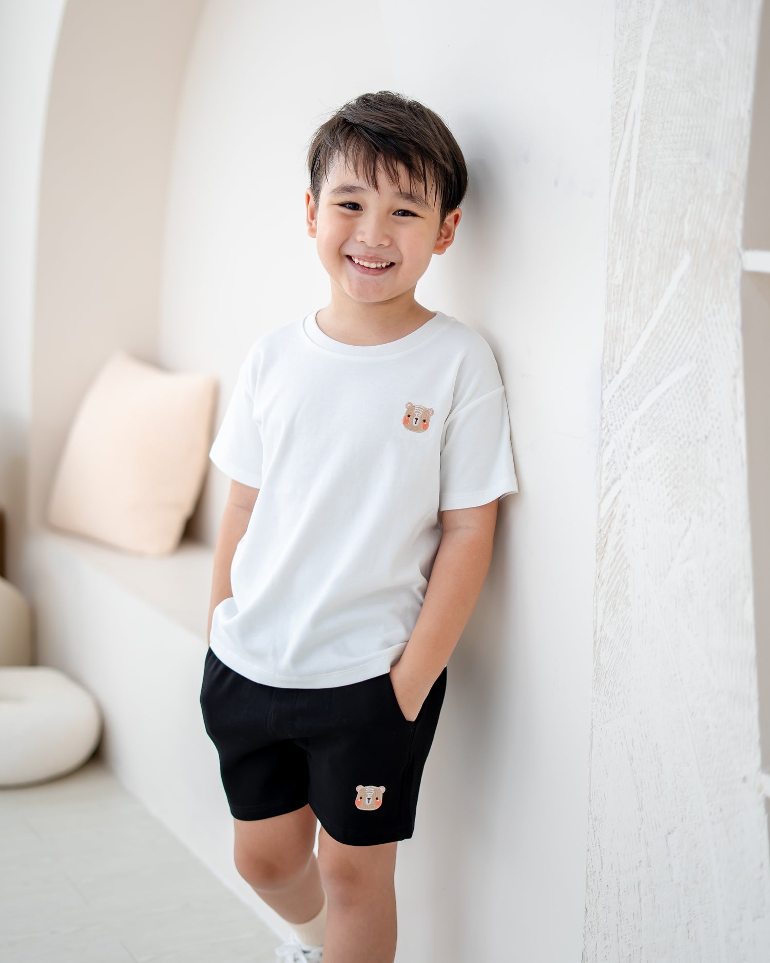 Boy wearing LeBear Signature black cotton jogger shorts with white T-shirt
