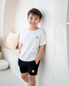 Boy wearing LeBear Signature black cotton jogger shorts with white T-shirt