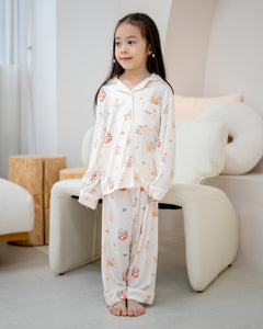 Girl standing in LeBear Kids Kaya Butter Toast Bamboo Pyjamas Set with long sleeves and relaxed fit.