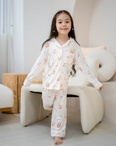 Girl walking in LeBear Kids Kaya Butter Toast Bamboo Pyjamas Set featuring button top and matching pants.