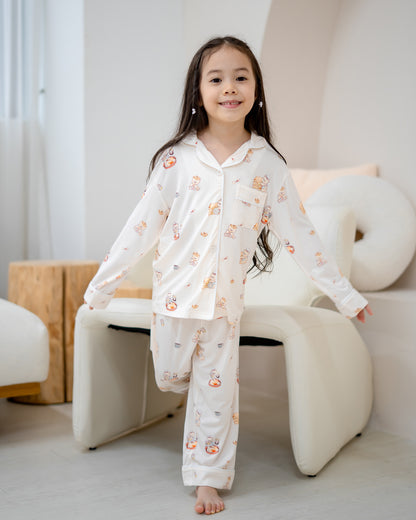Girl walking in LeBear Kids Kaya Butter Toast Bamboo Pyjamas Set featuring button top and matching pants.