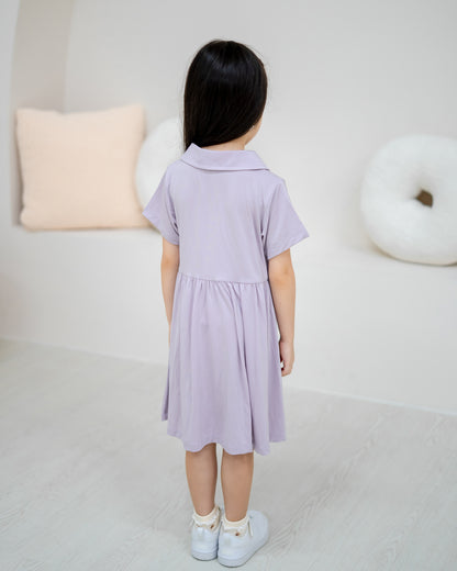 Back view of child wearing LeBear Kids TENCEL™ Collar Dress in Lilac with soft gathered skirt and rounded collar.