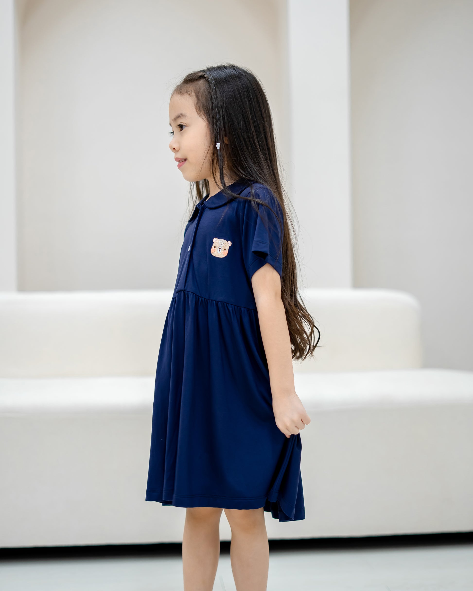 Side profile of child wearing LeBear Kids TENCEL™ Collar Dress in Navy showing soft drape and relaxed fit.