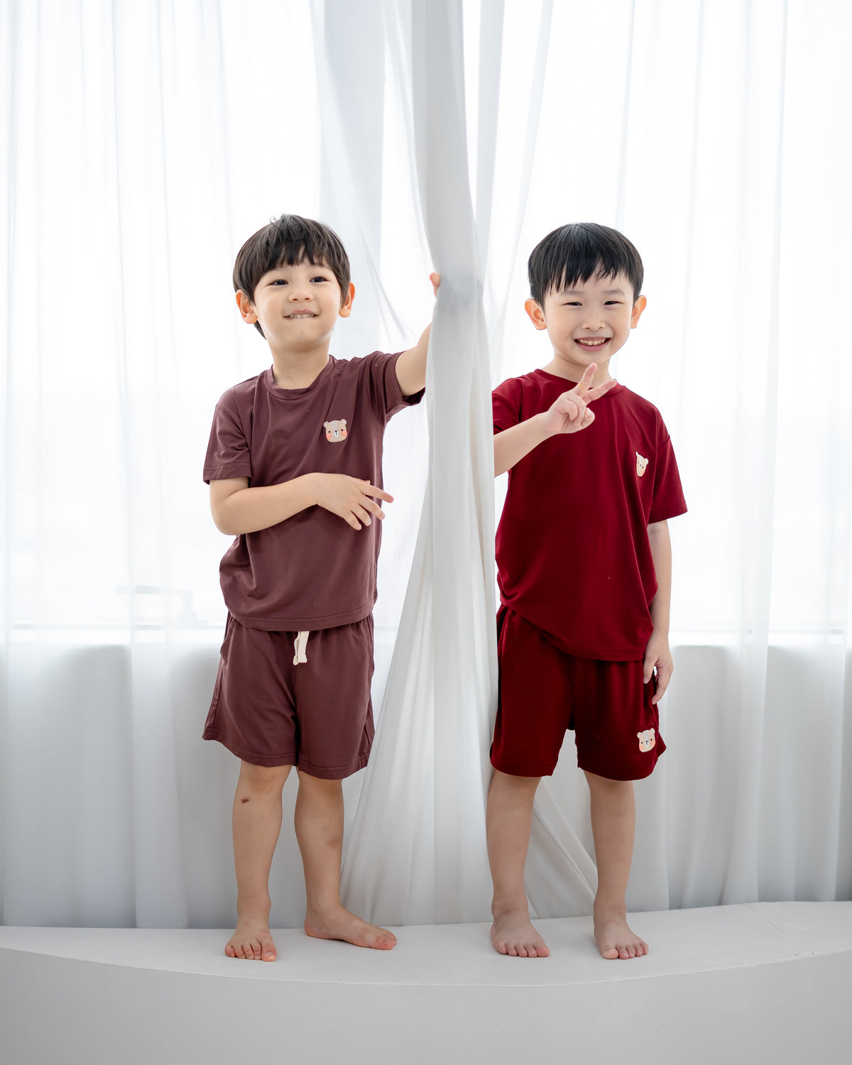 Kids wearing LeBear TENCEL™ Lounge Sets in Chocolate Brown and Ruby