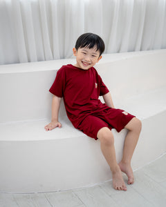 Boy in LeBear Kids TENCEL™ Lounge Set in Ruby with matching top and shorts