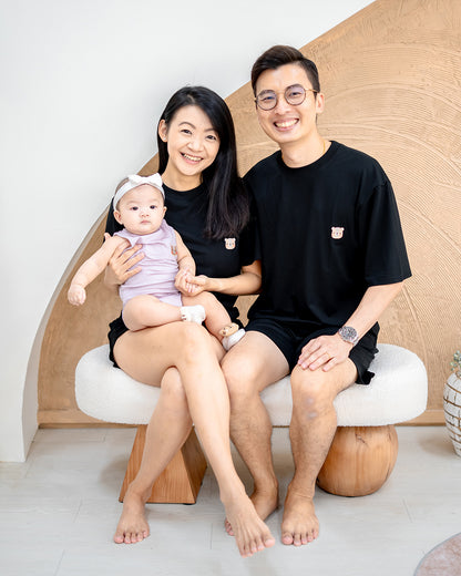 Family wearing LEBEAR TENCEL™ loungewear sets in black and lilac — breathable and soft matching sleepwear.