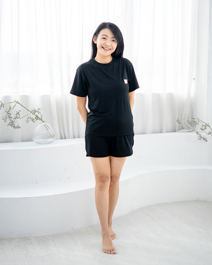 Woman smiling in LEBEAR Ladies TENCEL™ Set in Black — tag-less premium loungewear Singapore.