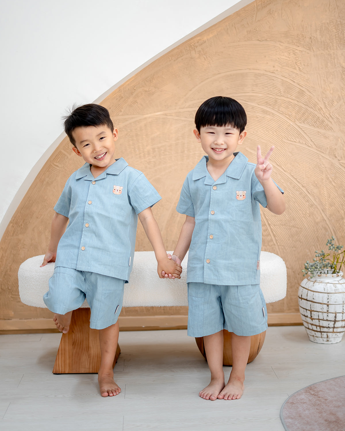 Kids holding hands in LeBear Liam Denim Camp Collar Set, breathable denim cotton outfit with camp collar shirts