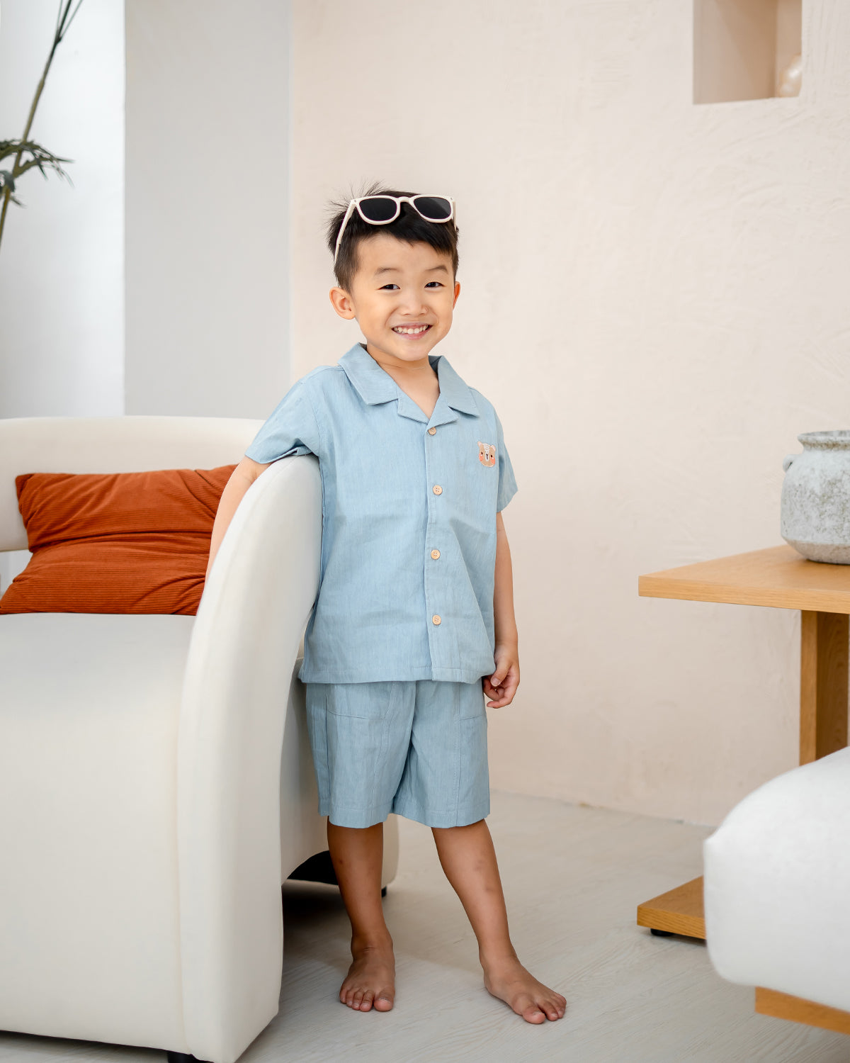 Boy posing in LeBear Liam Denim Camp Collar Set, soft tagless cotton fabric with functional drawstring shorts